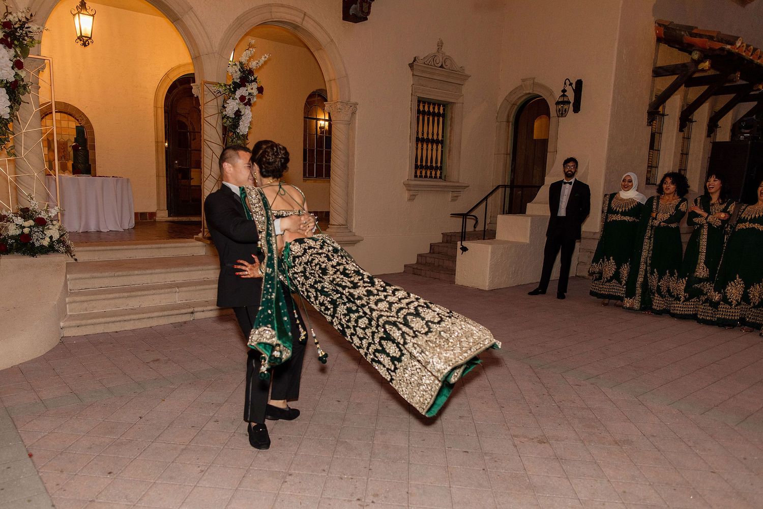 Night portrait of bride and groom on the wedding day with a venue on a background