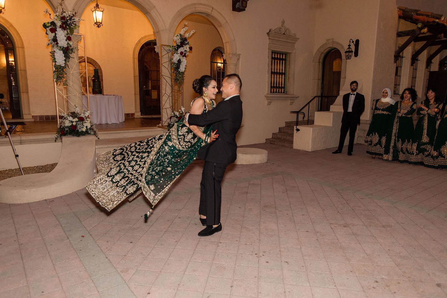 Night portrait of bride and groom on the wedding day with a venue on a background