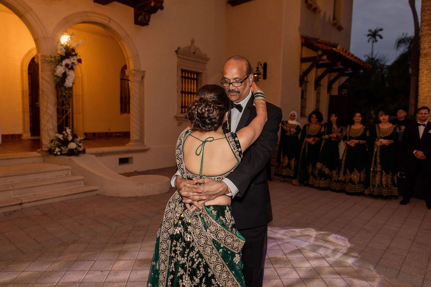 Night portrait of bride and groom on the wedding day with a venue on a background