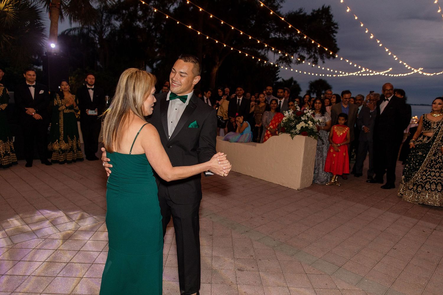 Night portrait of bride and groom on the wedding day with a venue on a background