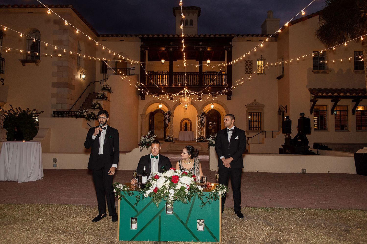 Night portrait of bride and groom on the wedding day with a venue on a background