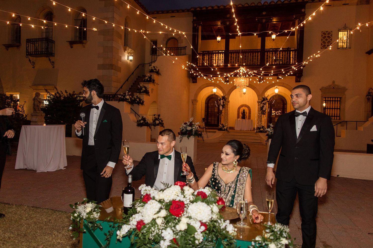 Night portrait of bride and groom on the wedding day with a venue on a background