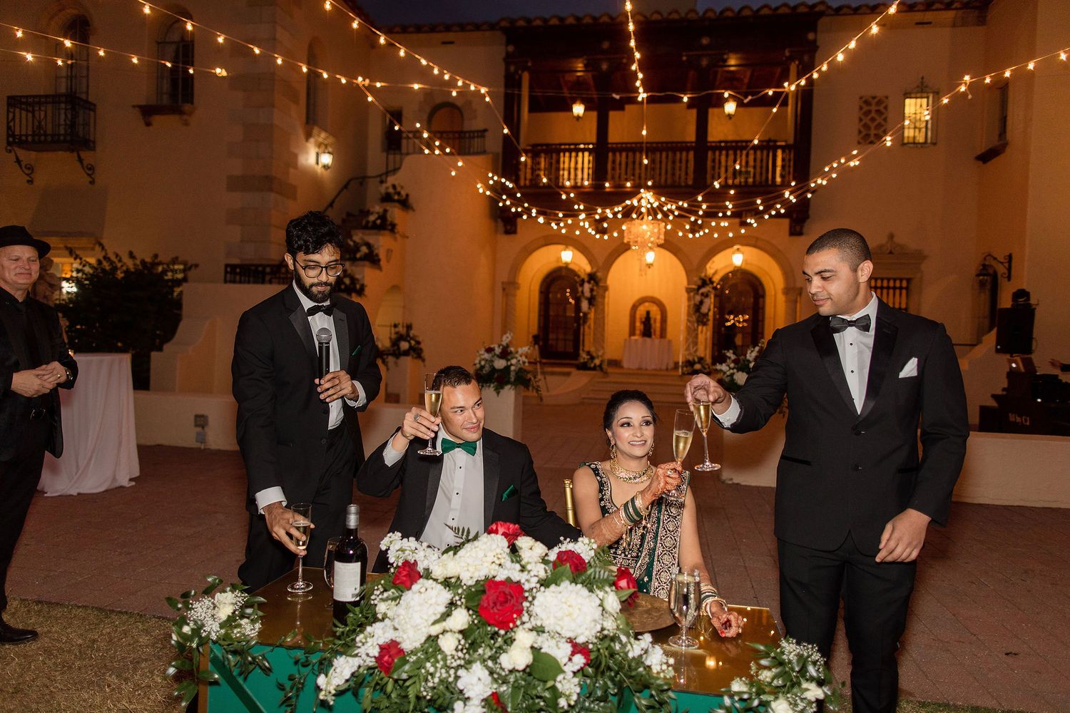 Night portrait of bride and groom on the wedding day with a venue on a background