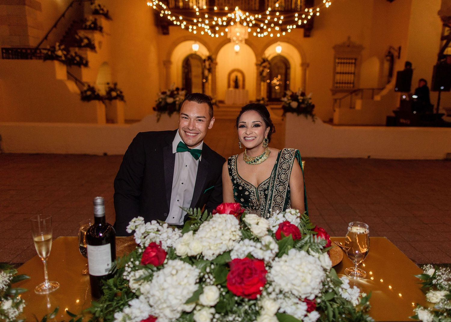 Night portrait of bride and groom on the wedding day with a venue on a background