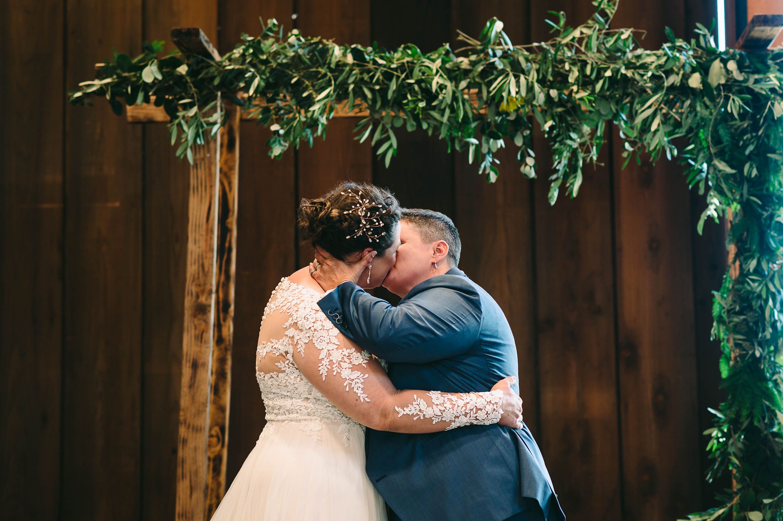Two brides have their first kiss at their LGBTQ wedding ceremony