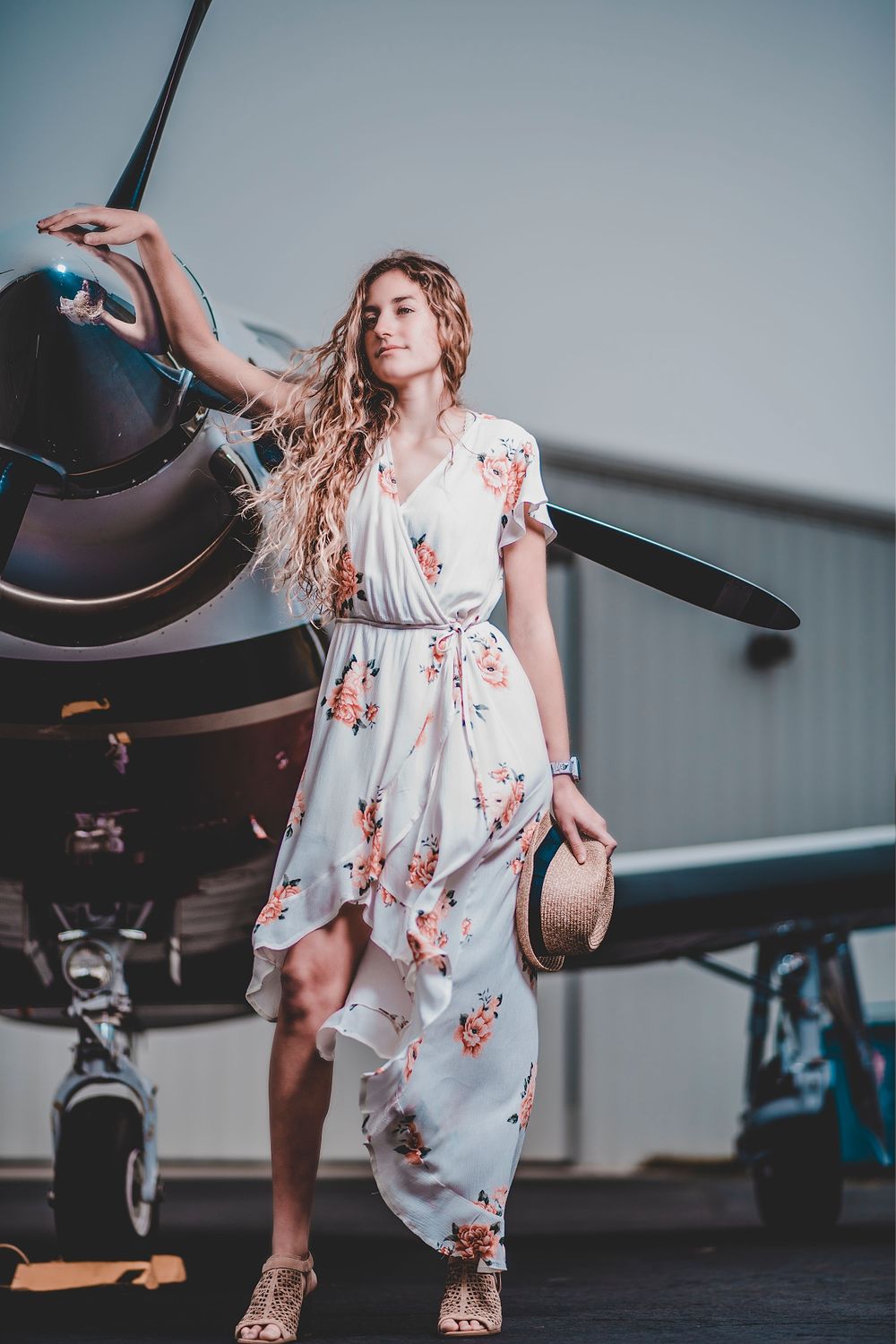 Fashion Portrait of girl in dress for senior photos with airplane
