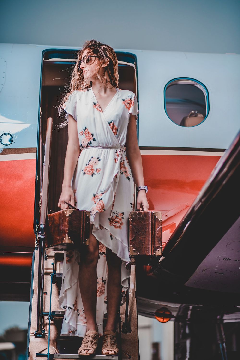 Fashion Portrait of girl in dress for senior photos with airplane