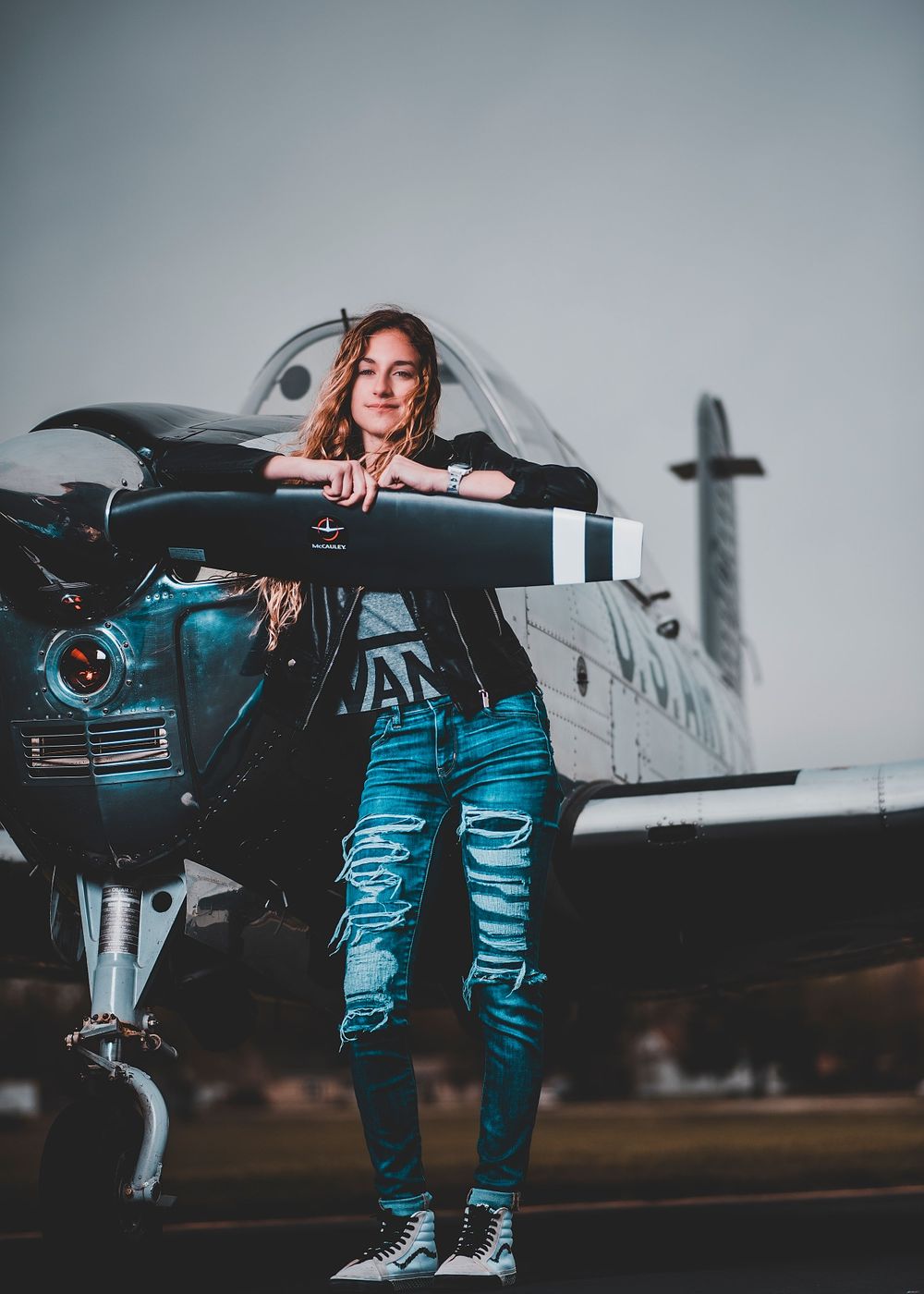 Fashion Portrait of girl in dress for senior photos with airplane
