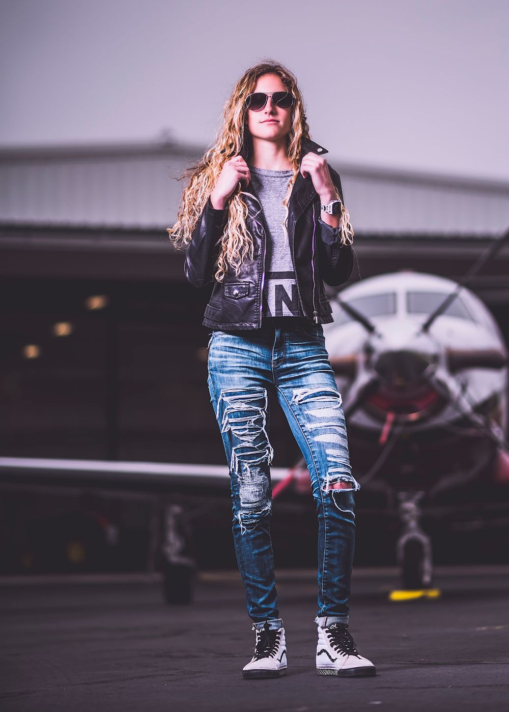 Fashion Portrait of girl in dress for senior photos with airplane
