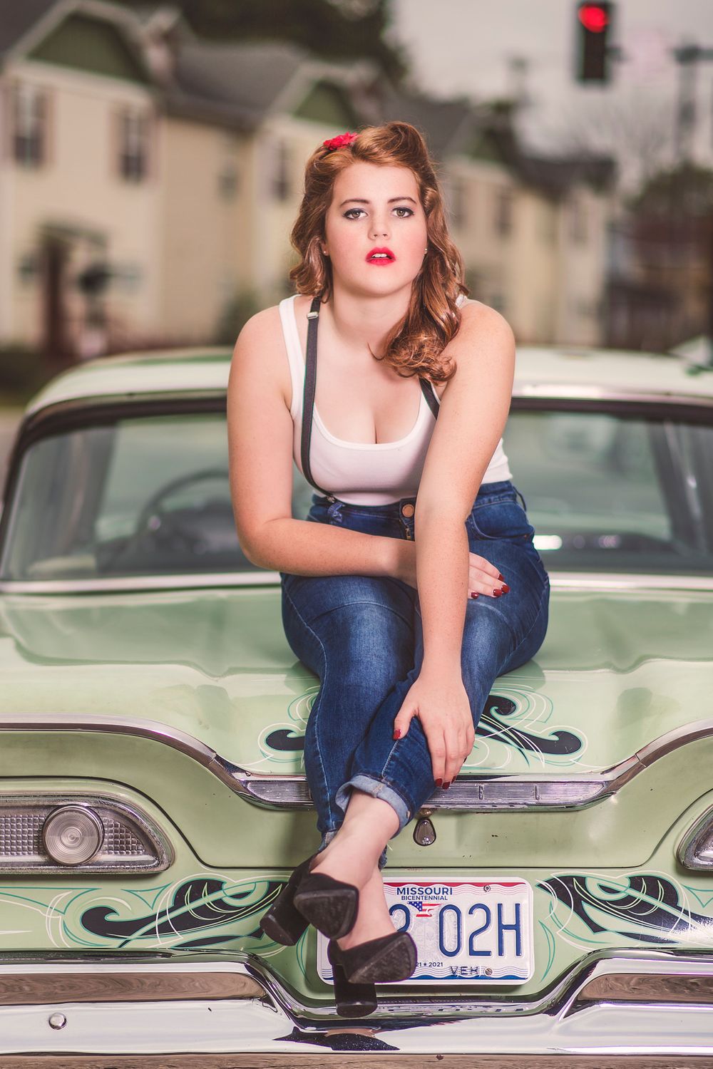 Fashion Portrait of girl in rockabilly outfit sitting on Edsel for model portfolio