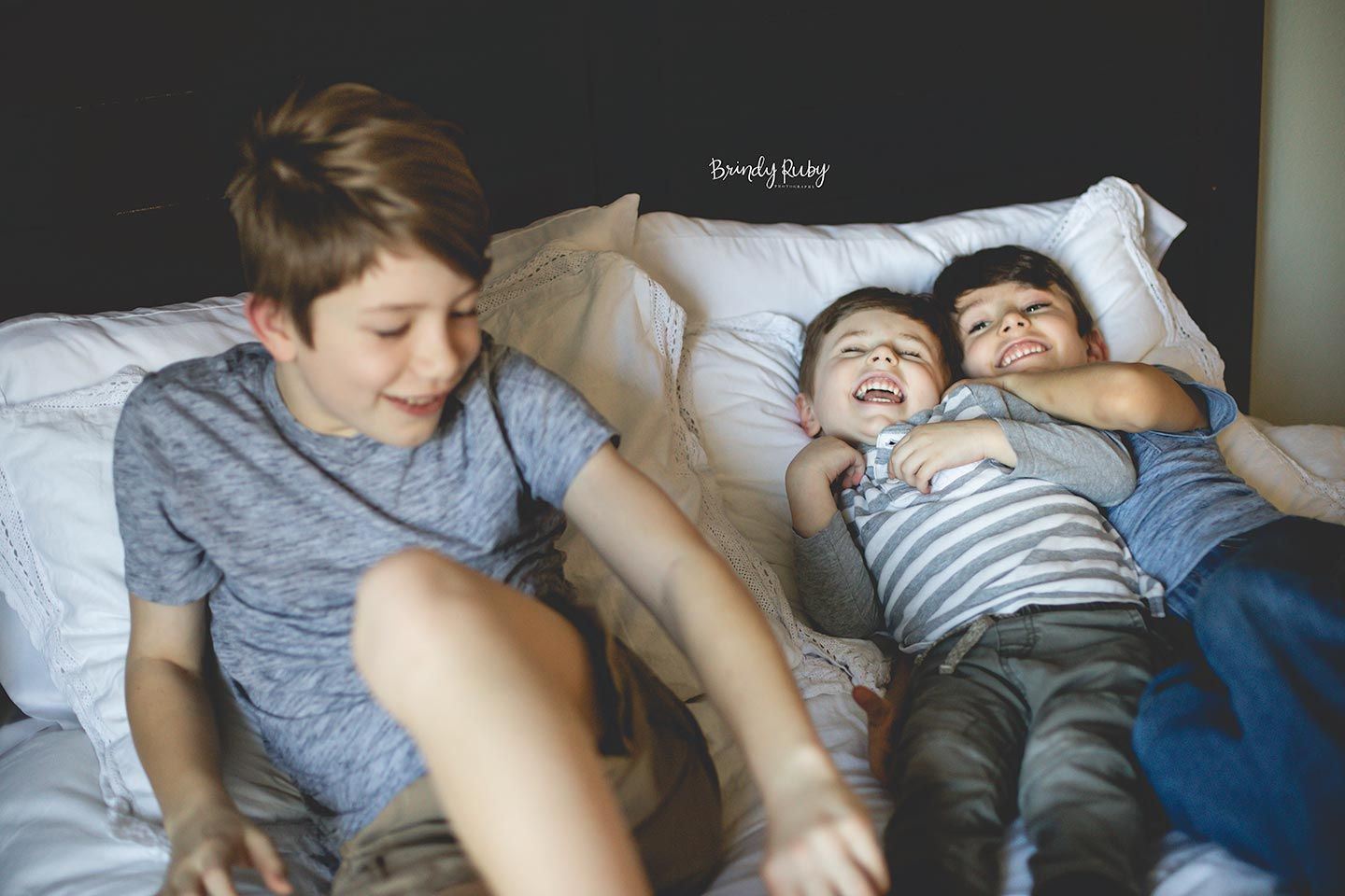 brothers having fun and tickling on bed