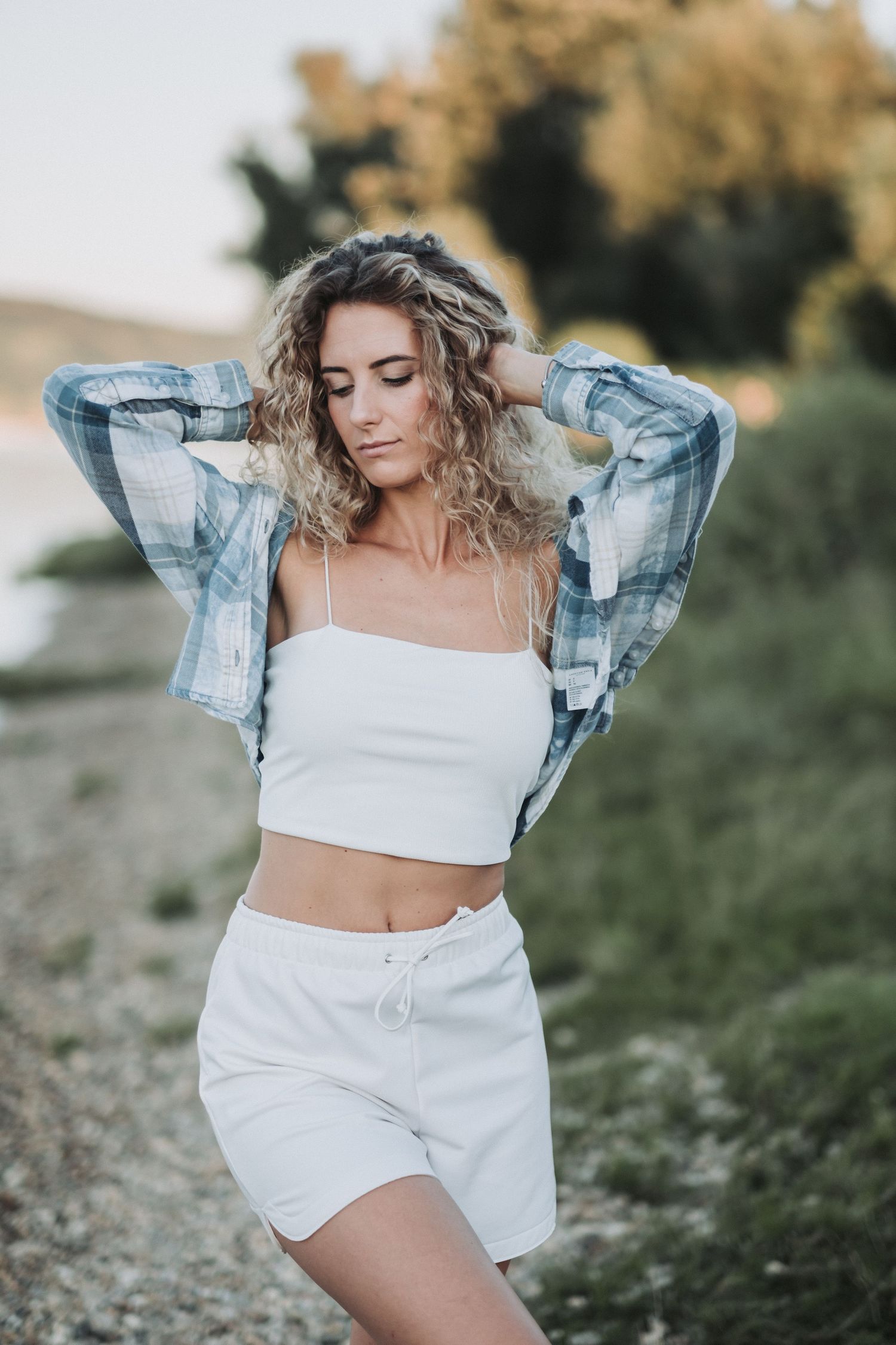 Casual summer style with plaid jacket and white coord set outdoors.