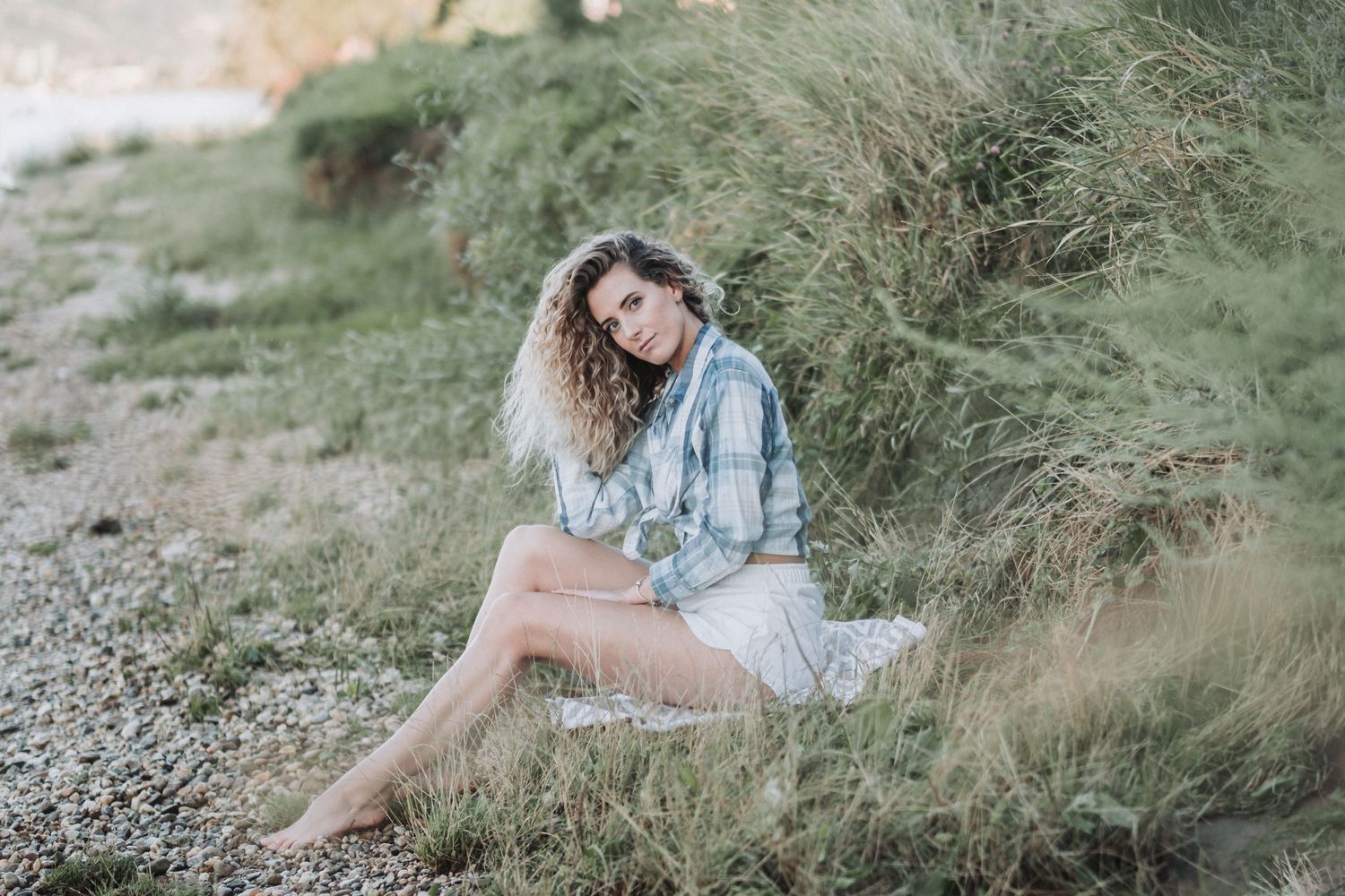 Dreamy beach fashion portrait with natural styling and soft lighting.