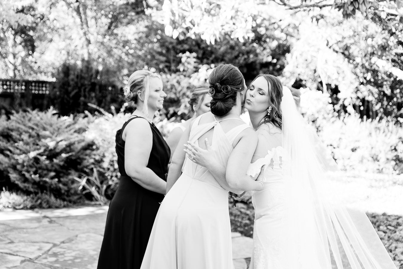 bride kissing her bridesmaid on the cheek before her Northern California Ranch Wedding