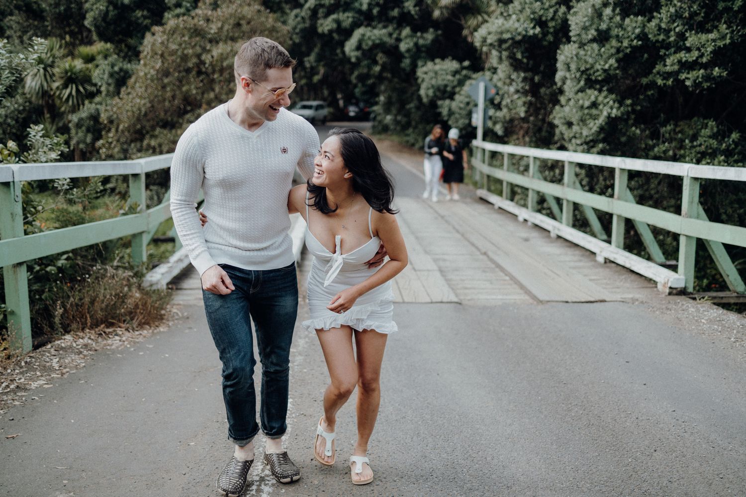 A couple walking to Karekare falls for their post-wedding photoshoot with Apertured Media-Auckland Wedding Photographer.