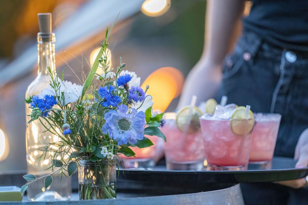 waitress holding a tray of cocktails at dusk at a surrey small event photography shoot