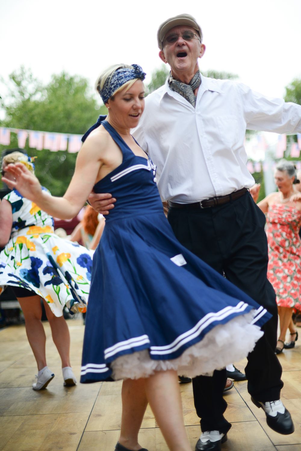 couple dressed in vintage clothing dancing at goodwood revival