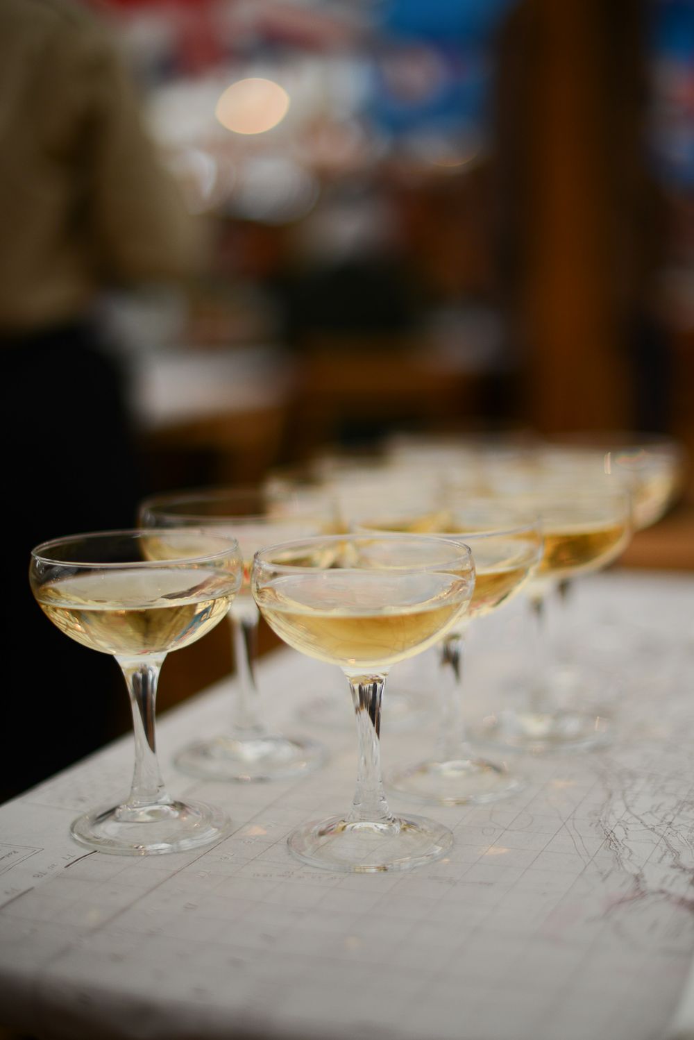 group of vintage champagne coupes at a dining table at goodwood revival