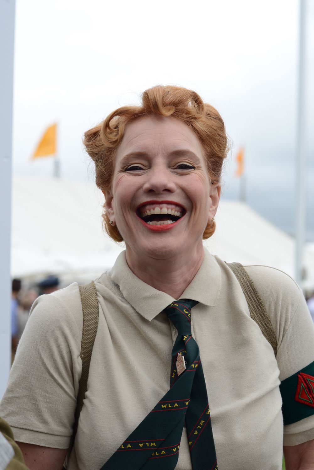young woman in vintage clothing laughing at goodwood revival