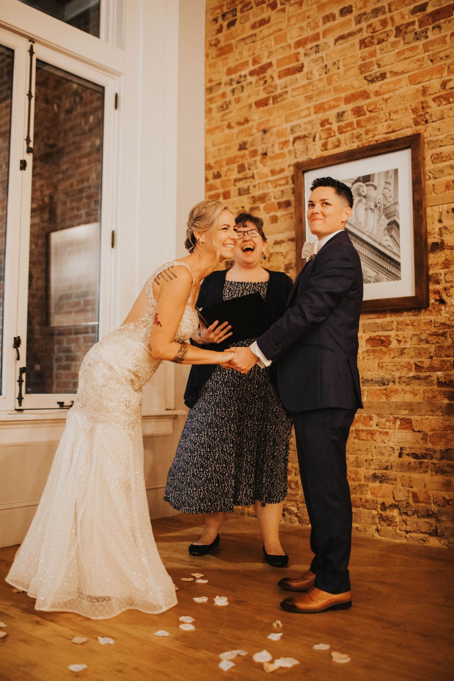 Couple laughing at wedding ceremony at Uptown Brewery in Greenville, North Carolina. LGBT Wedding.