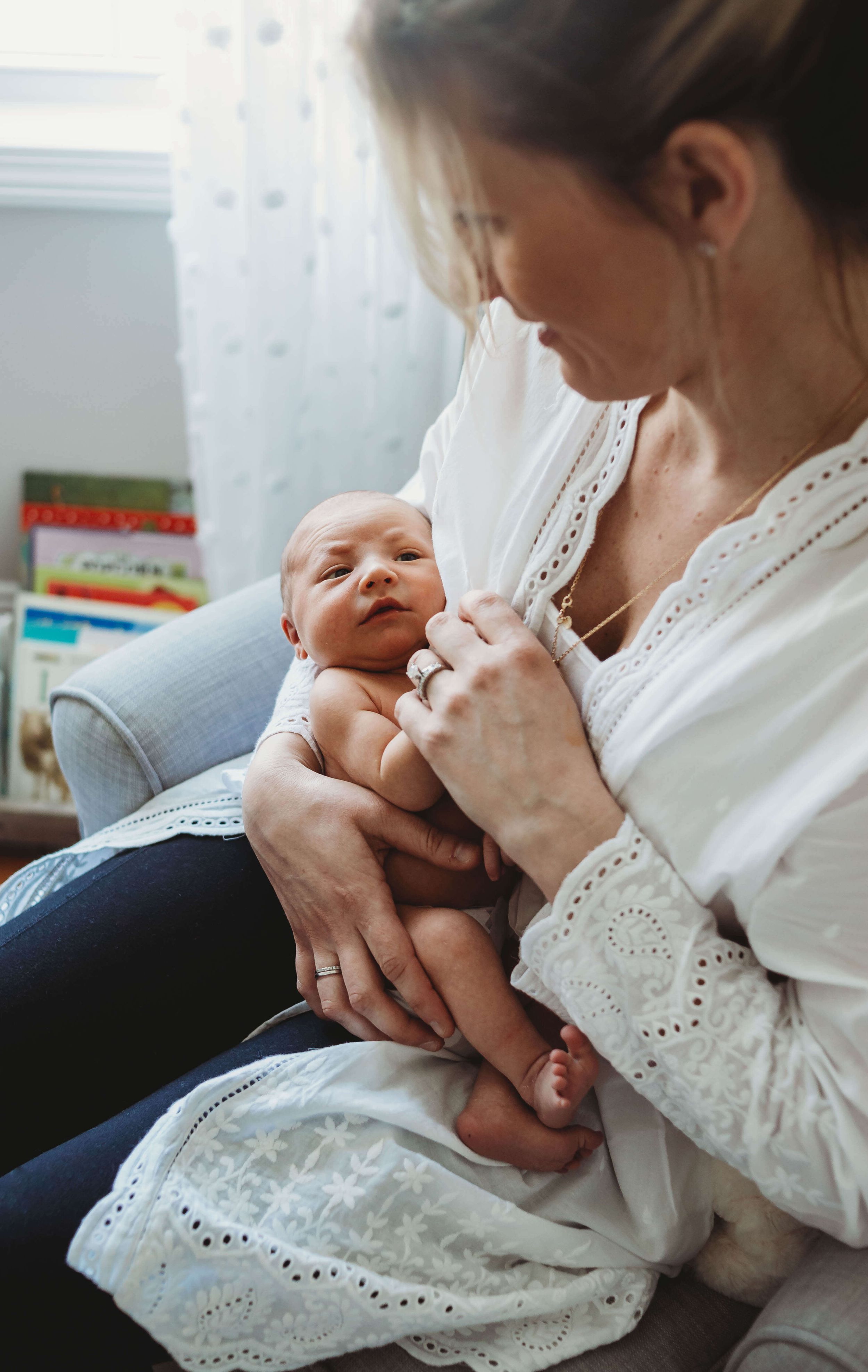 mom holding baby by boston newborn photographer