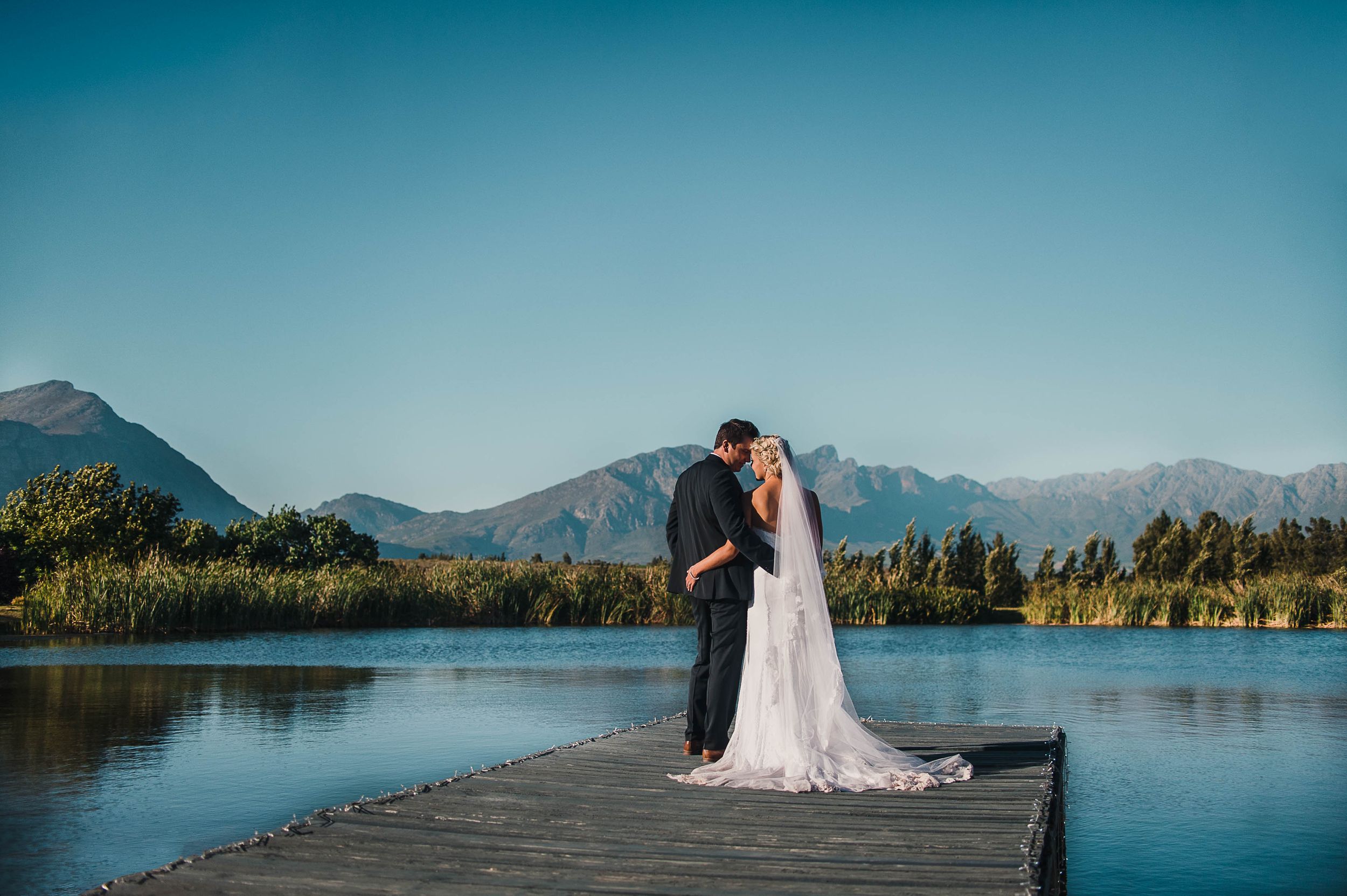 Bride and groom on the dock of the dam