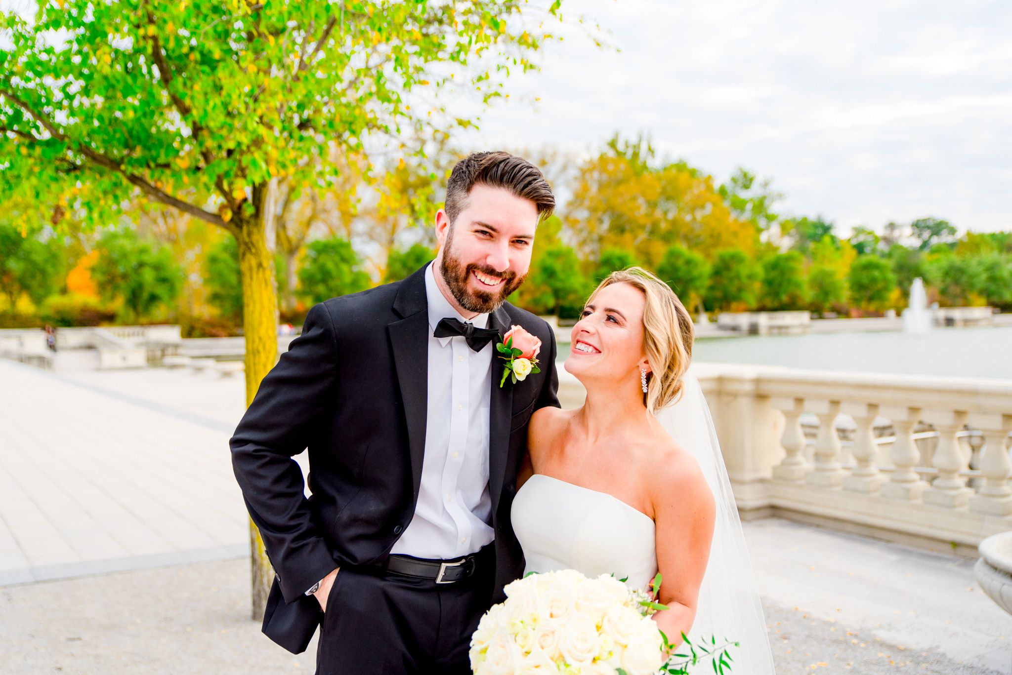 blonde bride smiling at brunette groom for fall wedding pictures in Forest Park STL
