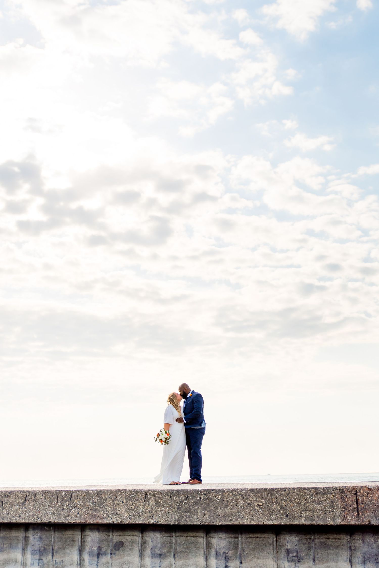 man and woman standing on pier for north avenue beach chicago wedding photos