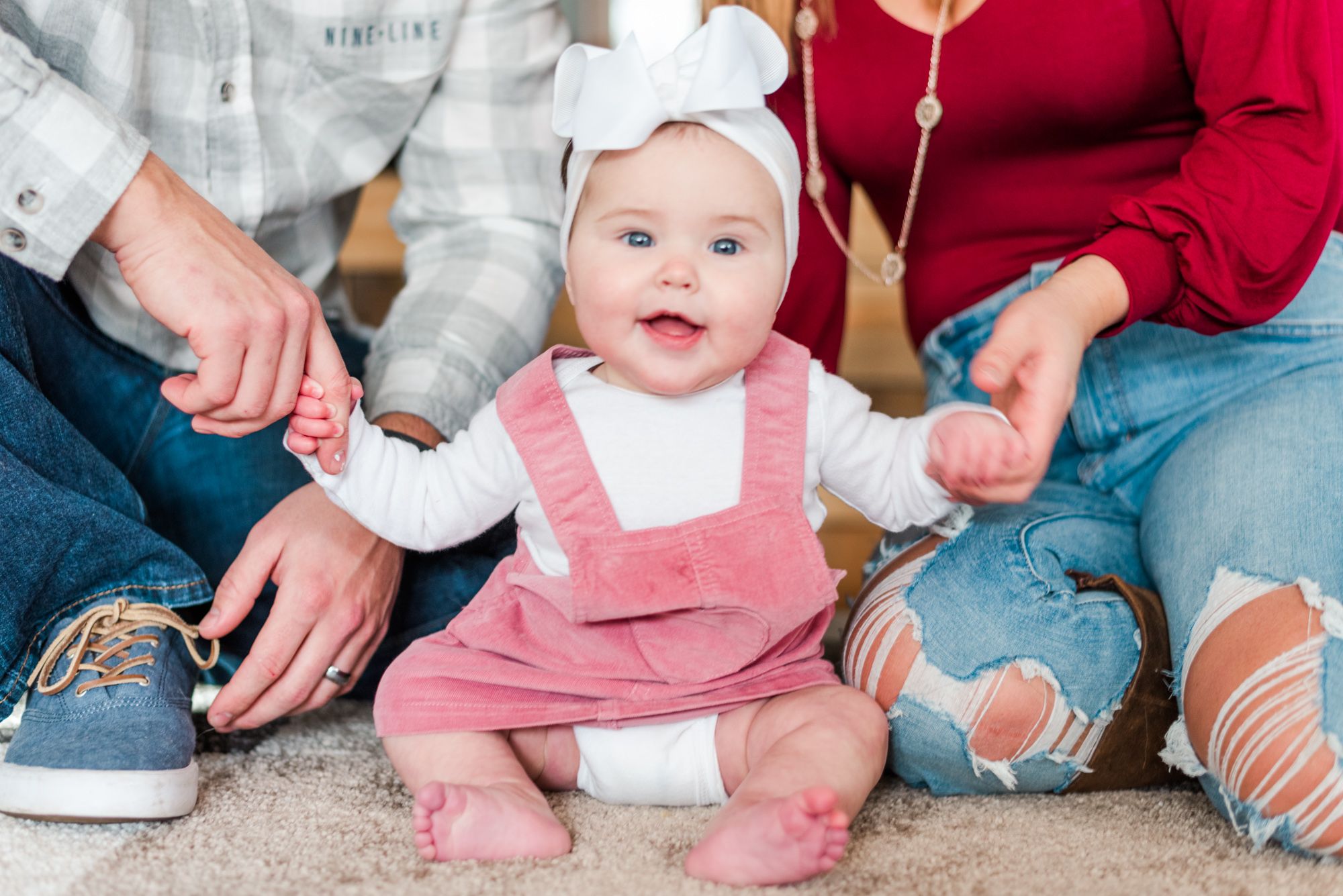 Lifestyle family photoshoot in the home with 6 month old baby wearing bow in Gibsonia, Pennsylvania