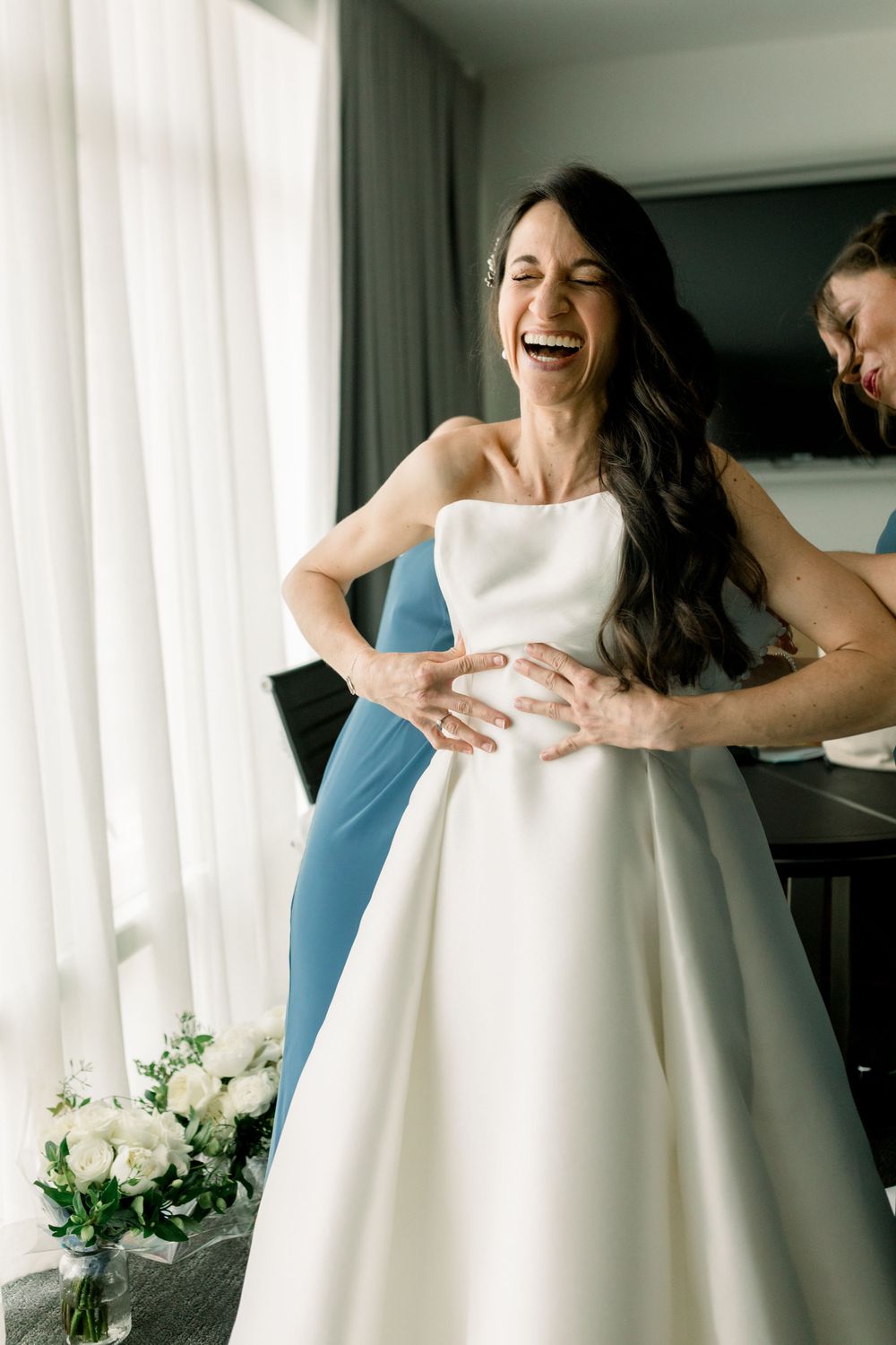 Bride laughing with bridesmaids in Boston