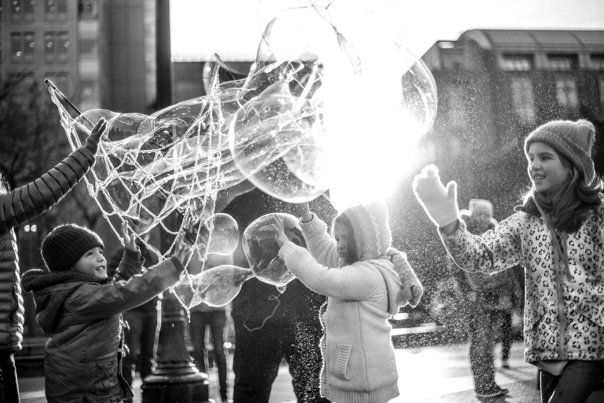 Children playing with bubbles in Washington Square Park, NYC
