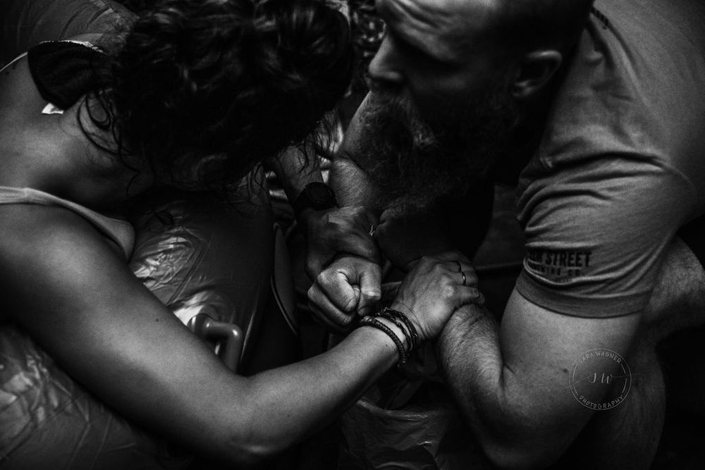 Mom labors at home birth with the support of her partner