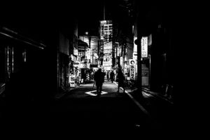 Black and white photo of office workers heading home in Tokyo Japan