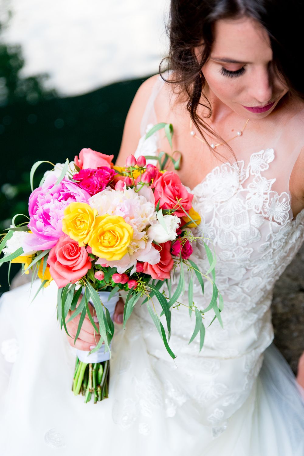 brown hair bride holding yellow and pink bouquet, wearing Serafina Gown by Kelly Faetanini