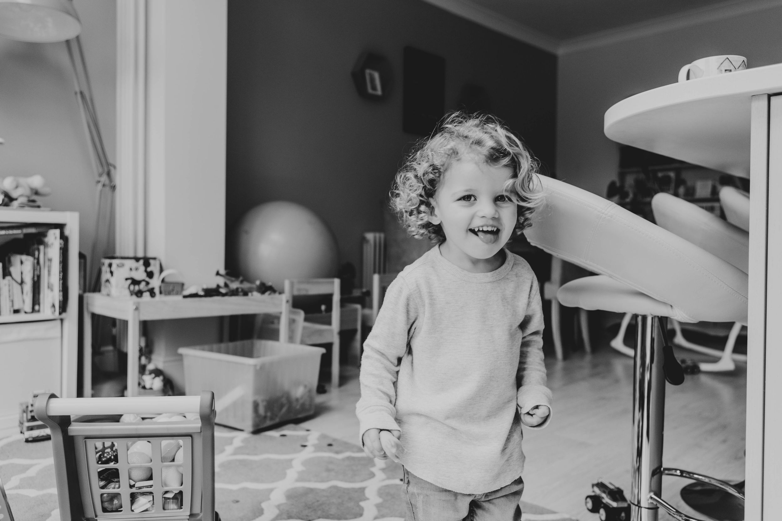 smiling blonde curly hair toddler boy