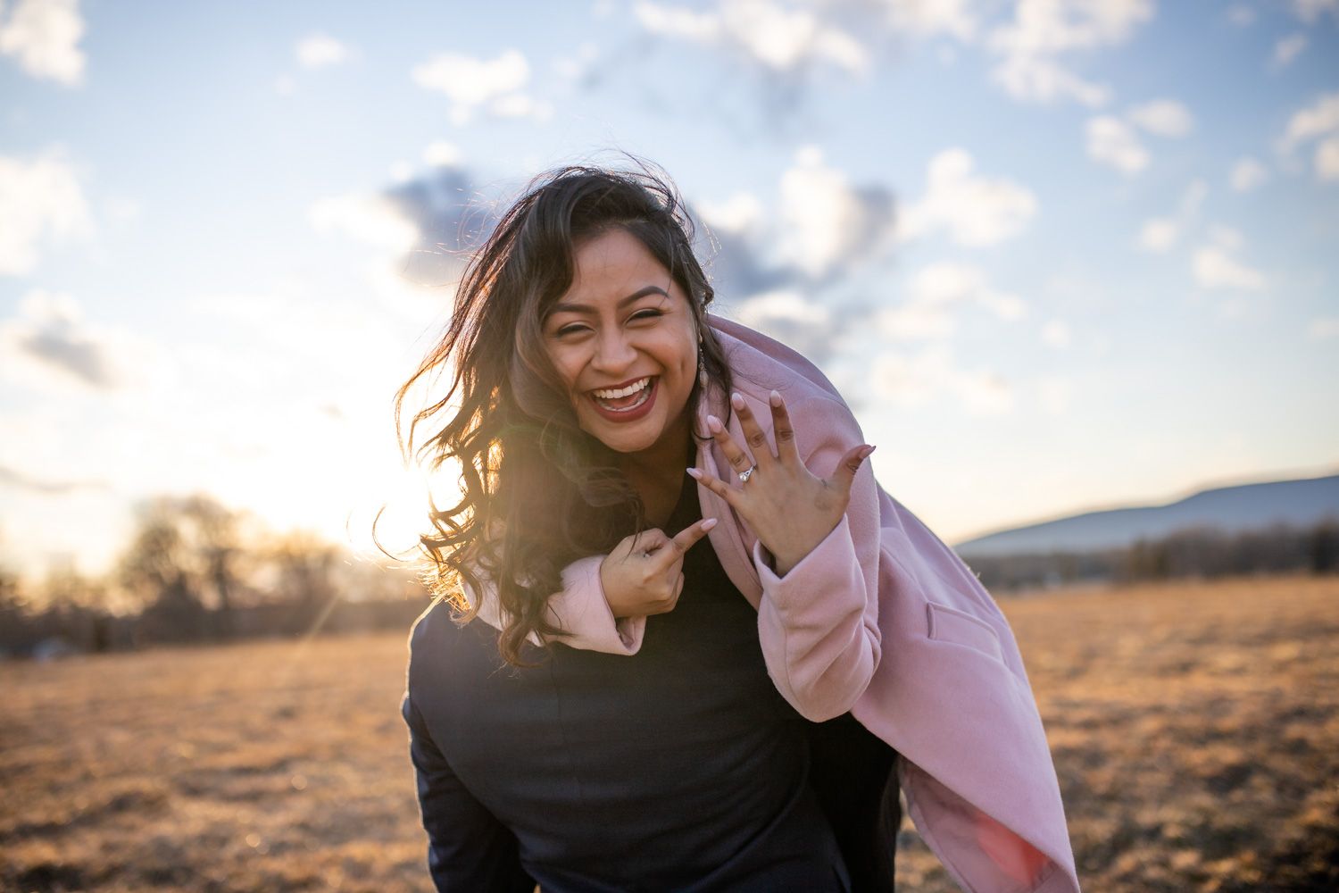 Engaged woman shows her ring during photo session