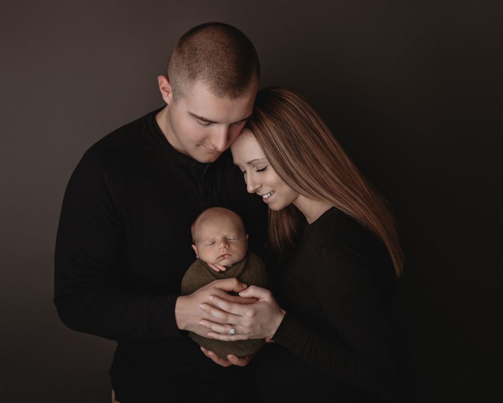 Professional newborn photo with mom and dad