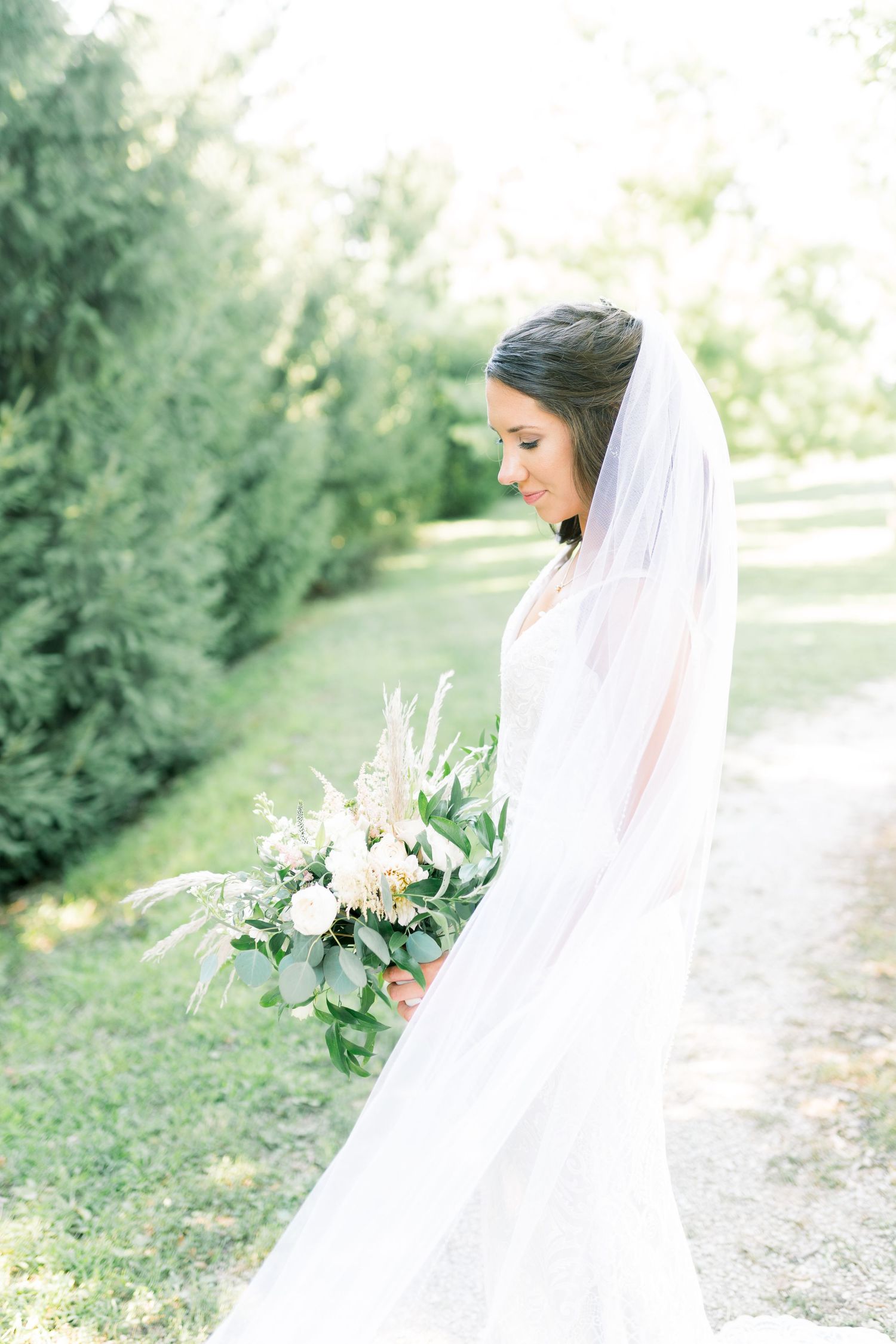 Veil wedding photos at Prairie Moon Winery in Ames, Iowa with White Willow boho florals