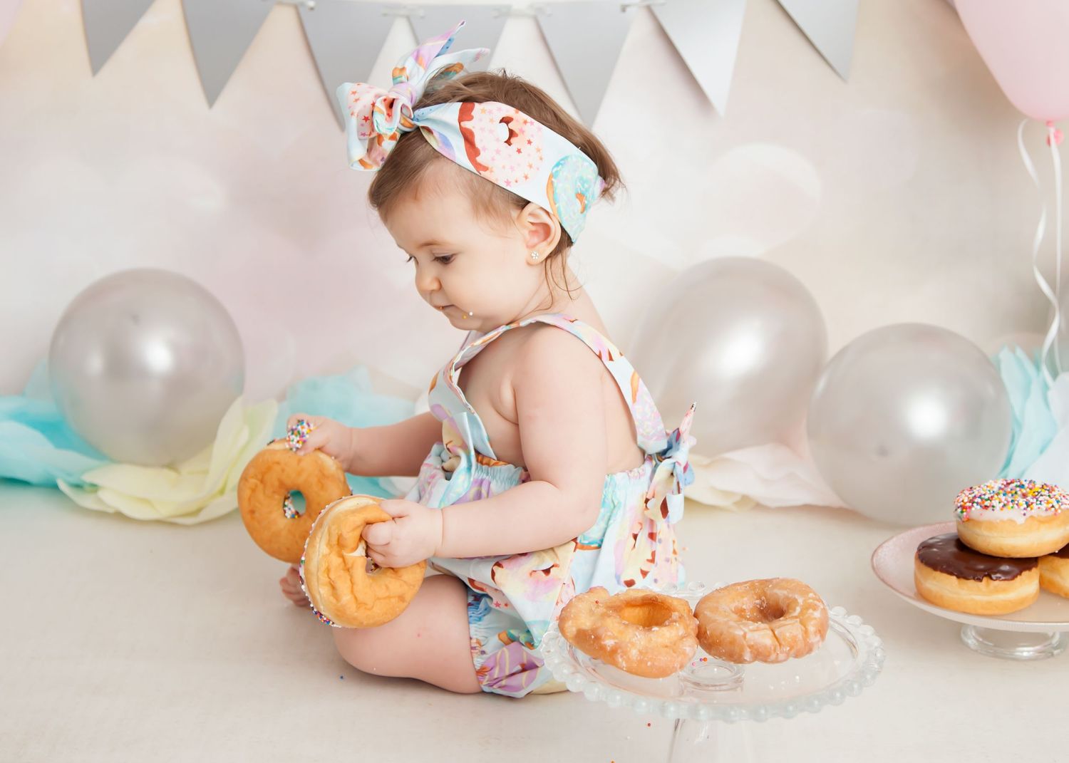 baby with donuts during cake smash photos