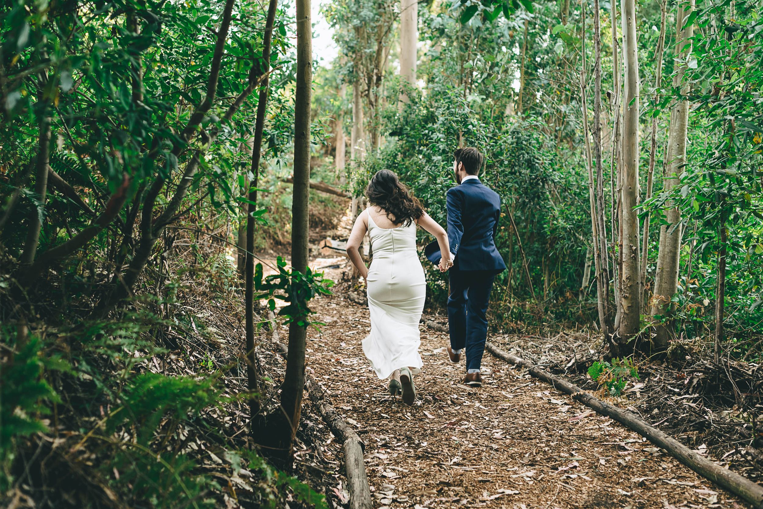 bride and groom running off together after wedding ceremony