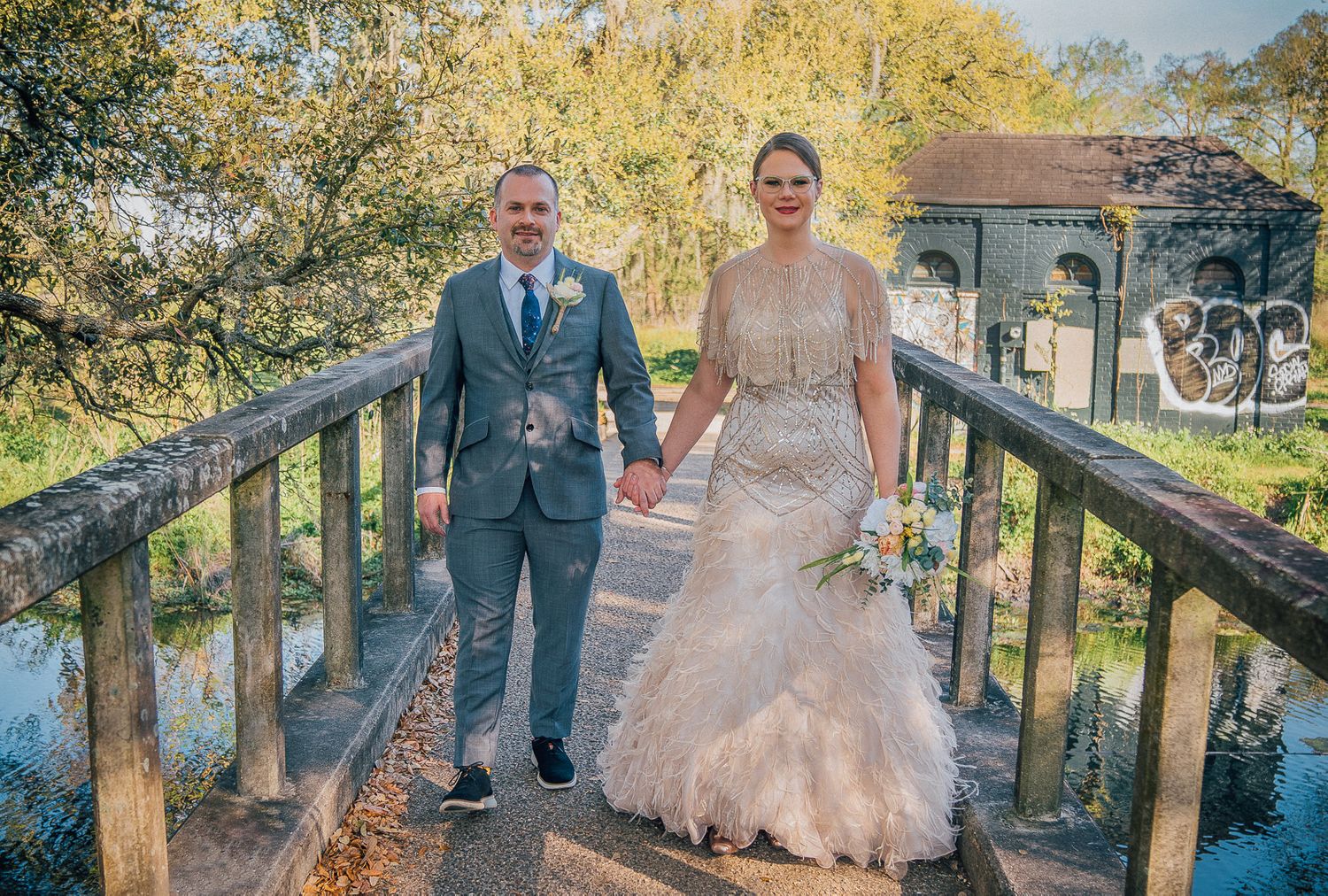 Bride and Groom in New Orleans City Park walking over bridge