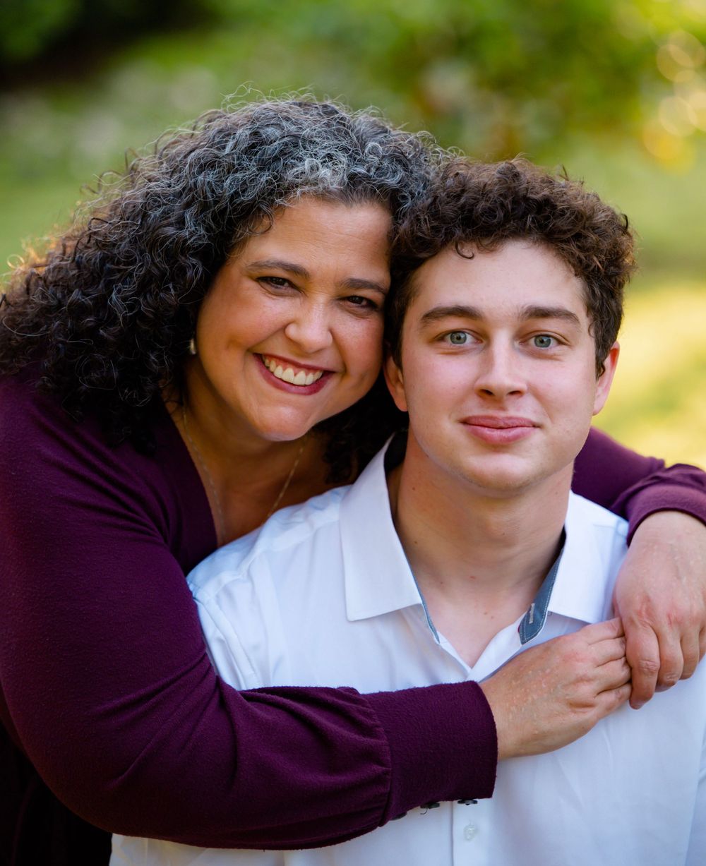 Close-up portrait of friends in coordinating white and purple outfits.
