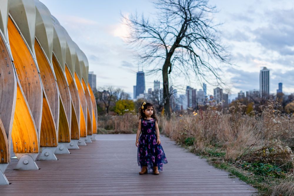 toddler girl waling by honeycomb installation Chicago family lifestyle session