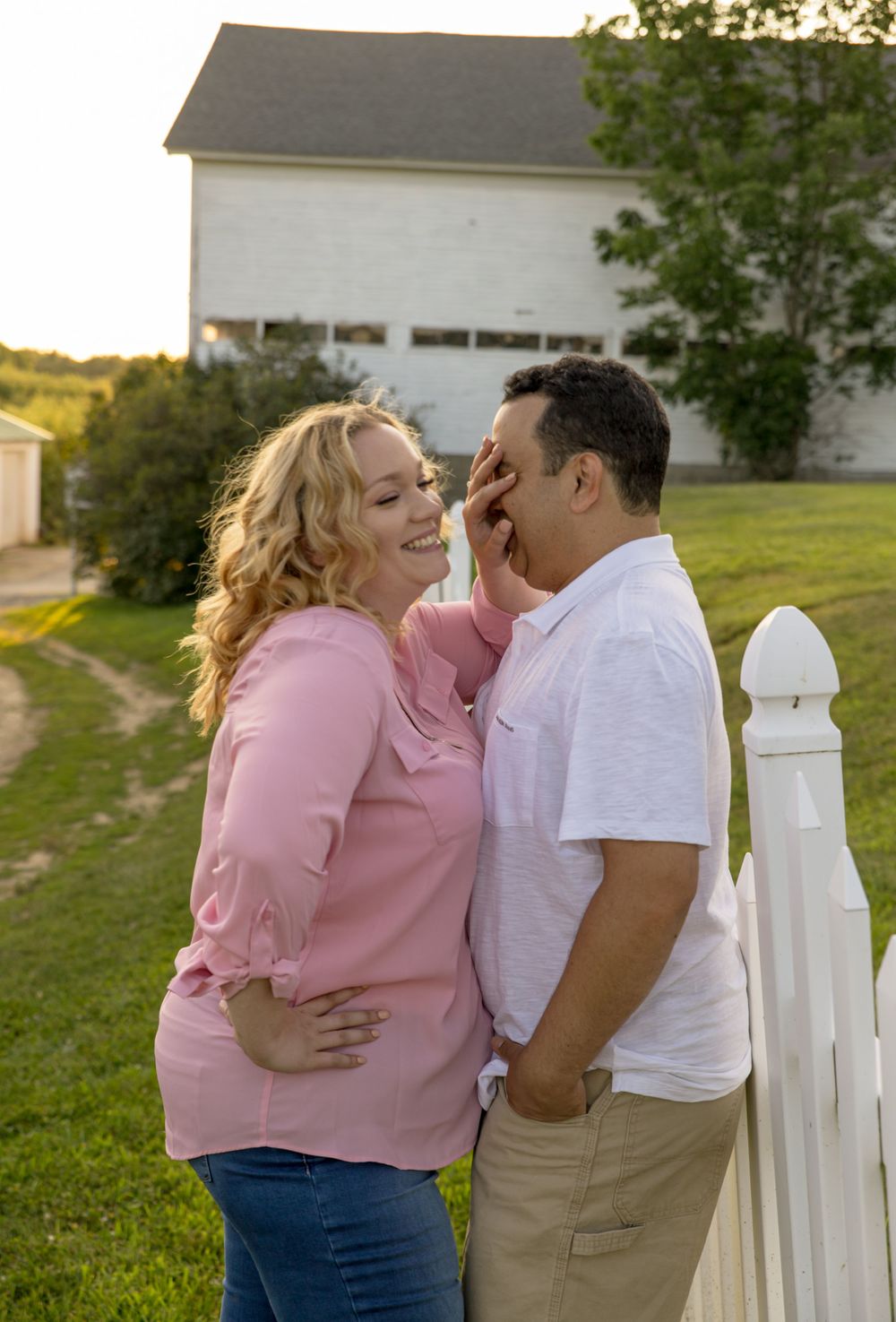 Playful Engagement Photography of Bride and Groom in green space