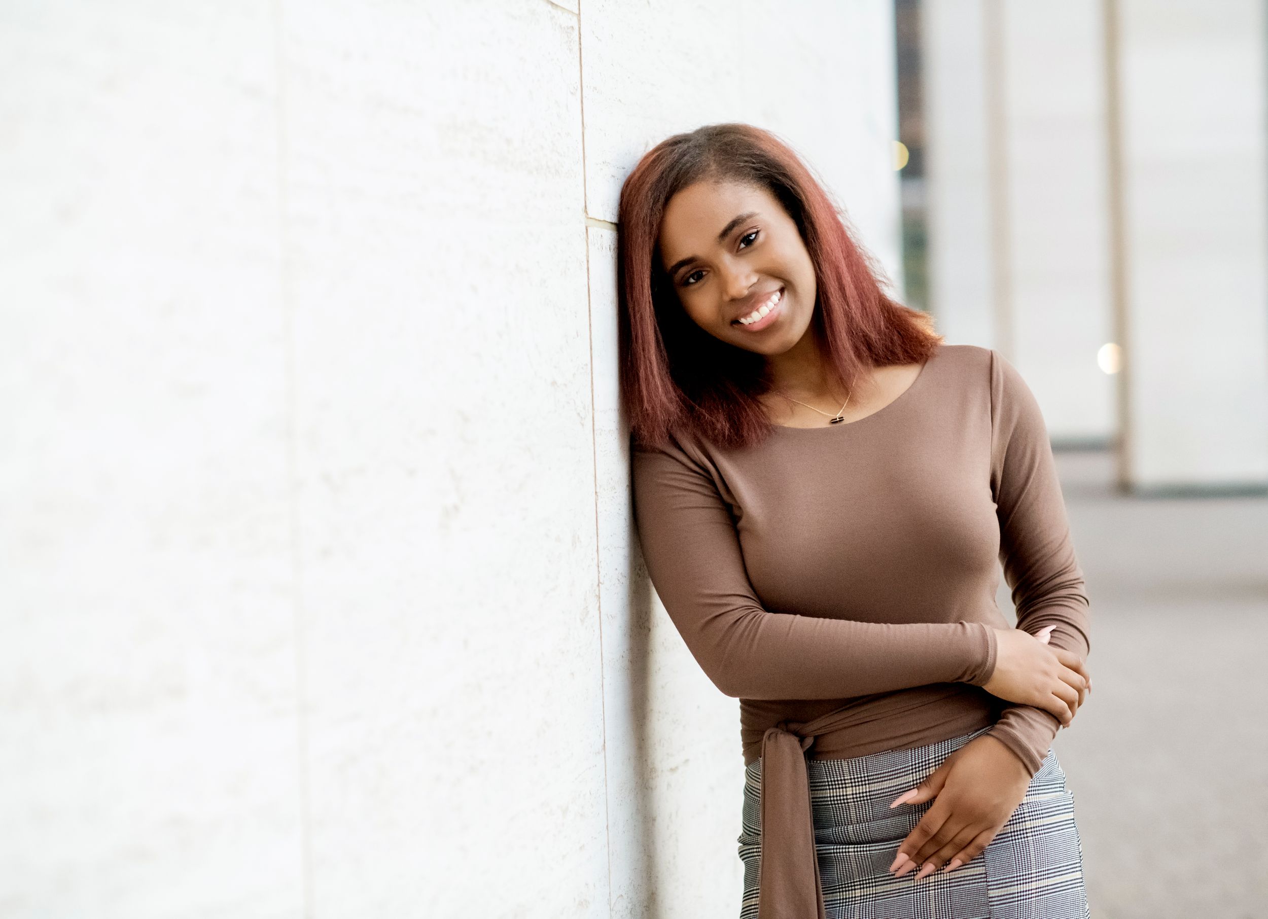 High School Senior Girl leaning on Wall at Houston Jones Hall