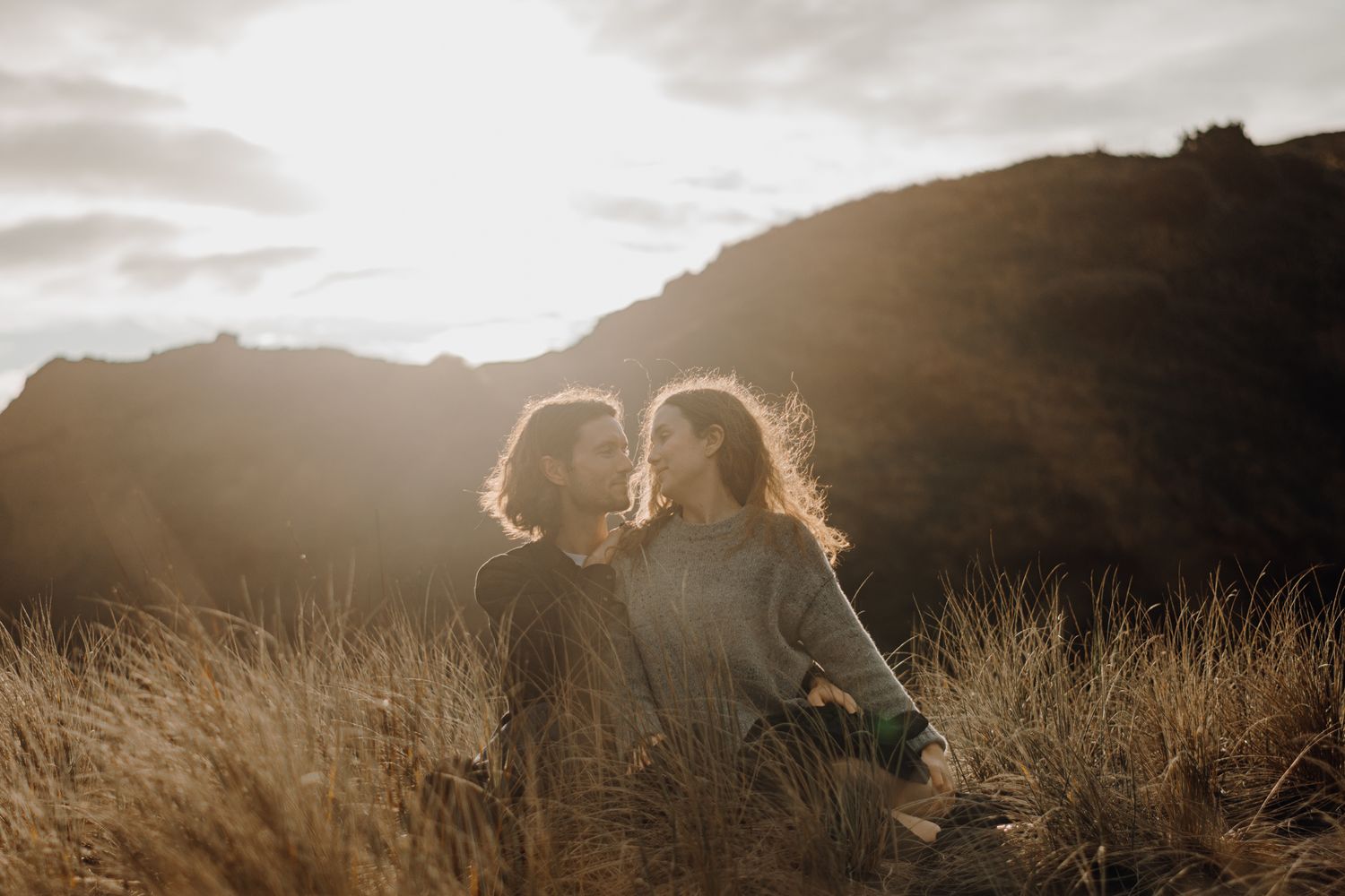A couple in Piha Beach sunset for their sunset session with Apertured Media-Auckland Wedding and Elopement Photographer