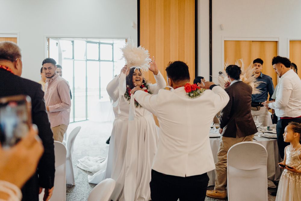 Joyful wedding celebration moment in a bright indoor venue.