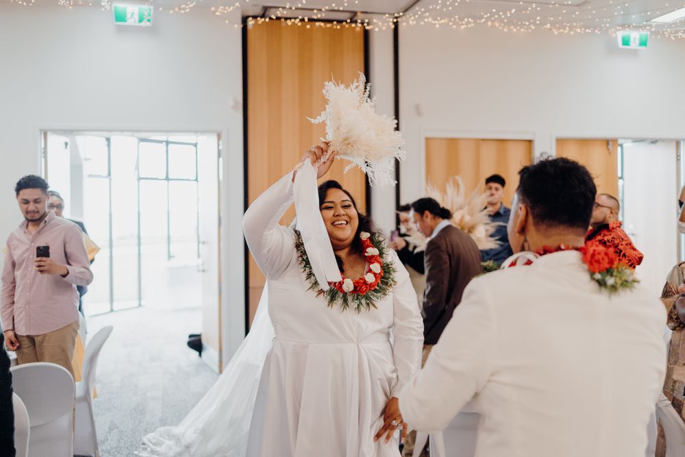 Celebratory wedding dance moment in a modern reception venue.