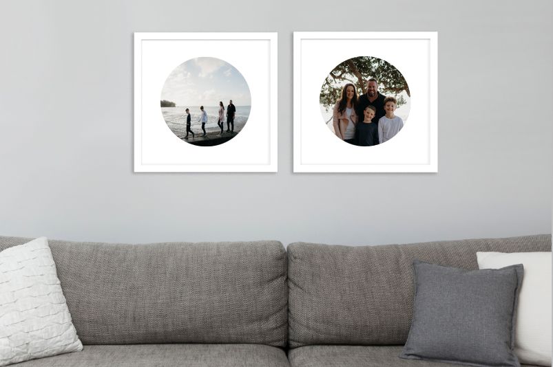 two circle framed images hanging above a couch