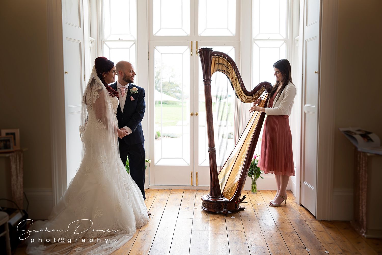 bride and groom and welsh harpist at St Tewdrics House